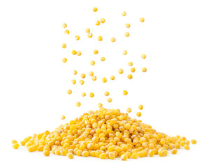 A pile of millet is poured close-up on a white background