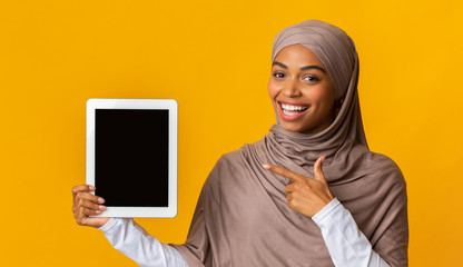 Black Muslim Woman Pointing At Digital Tablet With Black Screen