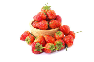 Fresh strawberries in a wooden bowl isolated on white background.