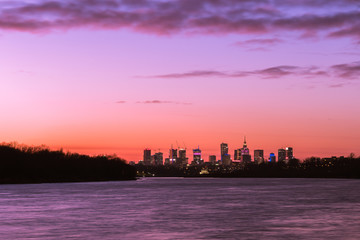 Fototapeta premium Warsaw skyline with skyscrapers during colorful sunset over the Vistula R