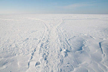 Footprints in the snow, frost, sunny weather.