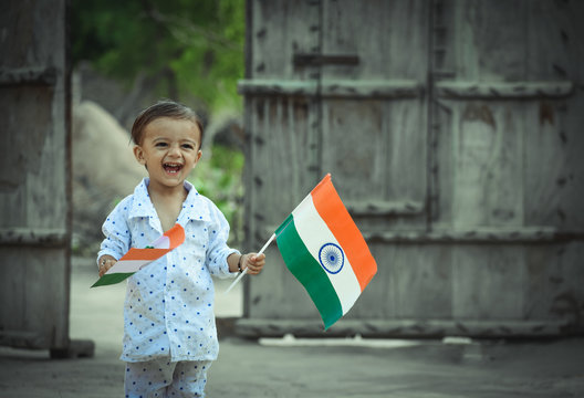 beautiful view of Indian kid with Indian flag in his hand
