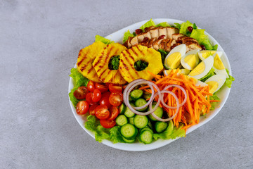 Healty colorful salad with vegetable and chicken breast.