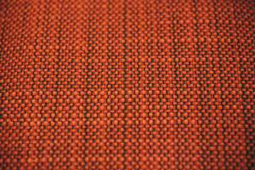 Obraz premium Macro view of orange fabric as texture and background for design. 