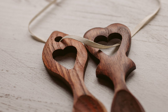 Traditional welsh wooden spoon in white background. Wooden love spoon.	