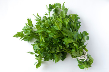 Bunch of parsley against a white background. Top view. Free space.