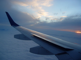 Fototapeta na wymiar A view over the wing of a plane