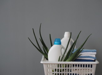 The concept of eco-friendly natural detergents. Detergents and cleaners with aloe vera plant on a...