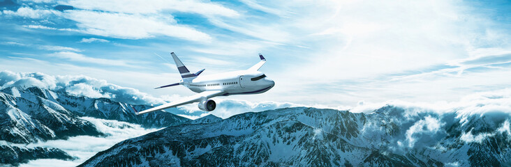 Fototapeta na wymiar Passenger plane flying above mountains in winter