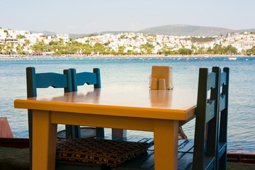 View of restaurant or cafe  on beach in Gumbet. Aegean sea,  Bodrum, Turkey