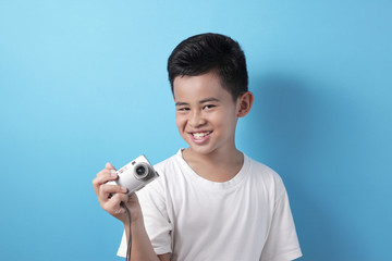 Happy Asian boy doing photography