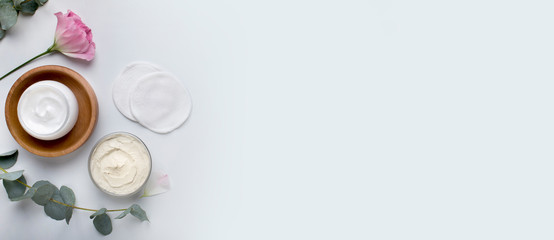 Facial moisturizing cream with flower petals, fresh pink rose