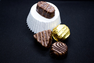 Various of sweet confectionery with chocolate candies and pralines. Handmade chocolates. Realistic chocolate set, delicious dessert pattern.