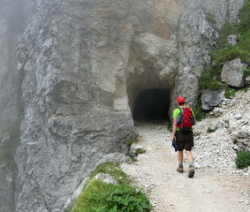 young hiker walks on a mountain path