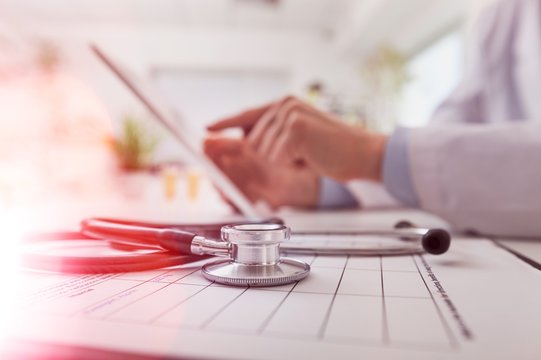 The Doctor Working With Laptop On Blurred Background