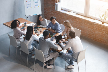 Creative international team discussing new project in modern office