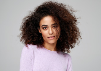 Fototapeta premium Portrait of beautiful african american woman with afro hairstyle isolated on gray background