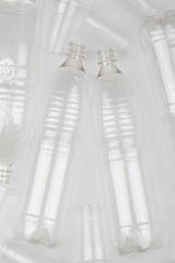 empty plastic bottles and glasses on white background.