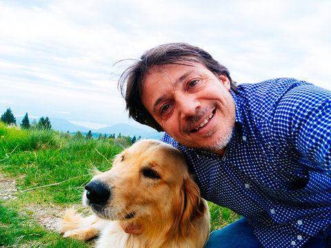 portrait of man with own dog self timer selfie
