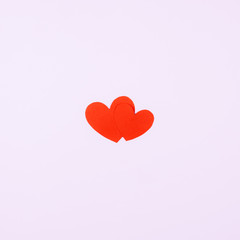 Two red hearts on a pink background. Postcard for beloved