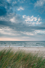 Late summer sunset on the Baltic sea coastline. Landscape of a beach near Ustka, Poland. - obrazy, fototapety, plakaty