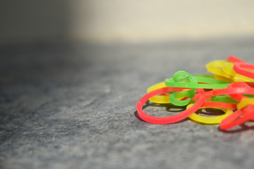 Vibrant and colorful rubber bands on a black surface