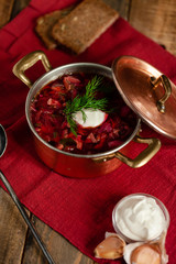 Freshly cooked homemade russian famous soup borsch. Served in cooper pan with garlic, sour cream...