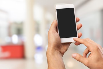 Male hands hold a cellphone with the blank screen
