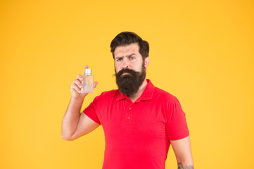 Freshness concept. Wearing perfume. Choose perfume for men according to occasion. Make sure smell fresh throughout day. Benefits using perfumes. Man well groomed bearded handsome hold bottle perfume