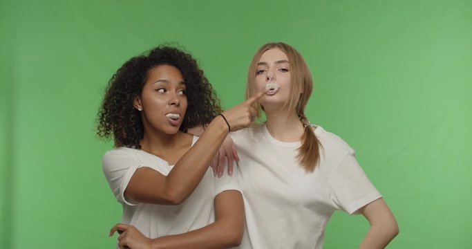 girls blowing bubblegum