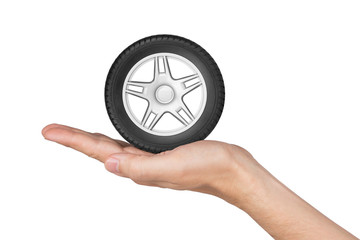 Hand holding car wheel isolated