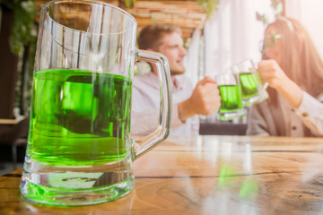Group of friends celebrating St. Patrick's Day at a pub