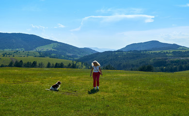 Woman and dog in a wonderful mountain landscape in spring
