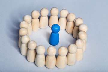 Leader concept. Wooden figures on grey background