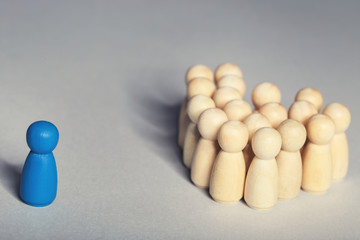 Leader concept. Wooden figures on grey background