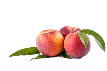 Fresh peaches with green leaf isolated on white background