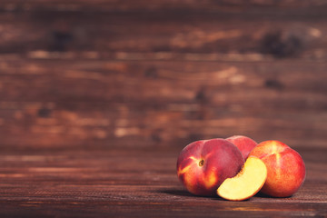 Fresh peaches on brown wooden table