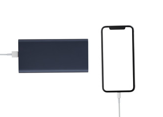 Power bank and smartphone on white background. The smartphone is charging from the power bank.