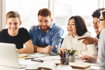 Team of college students talking over group project