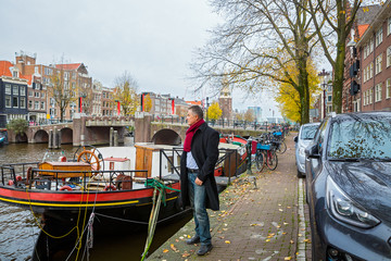 Fototapeta na wymiar Man travels and walks along the Amsterdam