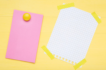 Paper sticky note with white sheet of paper on beige background