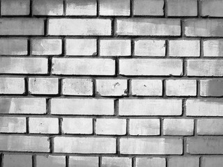 Brick wall with a white spot in the center of the image, background