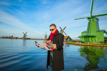 Man with a map walks  in Zaanse Schans