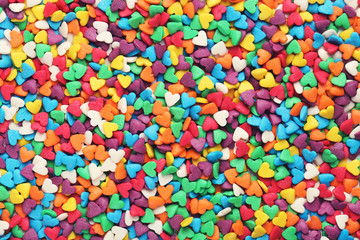 Fototapeta na wymiar Background of colorful heart shaped sprinkles