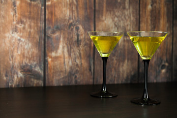 two yellow cocktails glasses