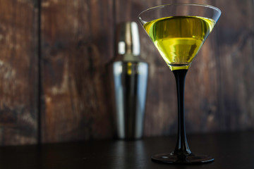yellow cocktail glass and cocktail shaker