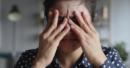 Frustrated stressed young indian woman coping with headache migraine, closeup - Powered by Adobe