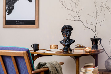 Stylish composition of elegant personal accessories at private library interior with bookstand and vintage table. Retro home decor. Candles, photo camera and a lot of books. Template. Close up.