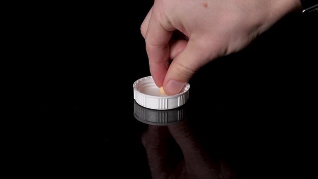 Prescription Pill Being Poured Into a Cap, Picked Up and Taken by person