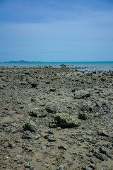 Stone courtyard on the public beach,Beautiful seascape with natural stone yard on beach against cloudy sky,Rocky shore at the seacoast with seascape and blue sky,